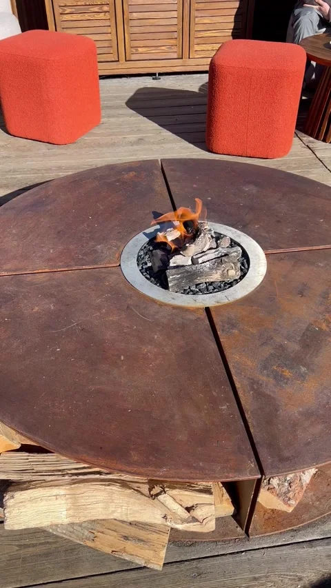 Outdoor fire pit at the terrace of a restaurant in ski resort Courchevel Stock Footage 337244204