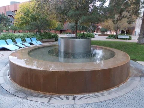 Outdoor fountain with background trees Stock Photos