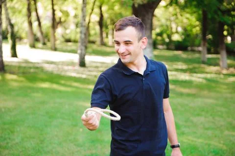 Outdoor games - guy playing ring toss in a park. Stock Photos