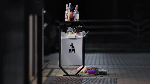 Outdoor garbage can overflowing with empty plastic glass soda beer bottles, Stock Footage 342923161