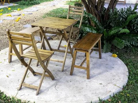 Outdoor garden table set. Empty wooden table with two chairs and two benches  Stock Photos