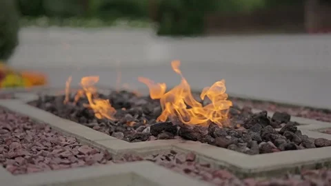Outdoor gas fire pit with dancing orange flames Stock Footage 346299056