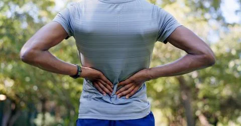 Outdoor, hands and runner with back pain for fitness, poor posture and Stock Photos