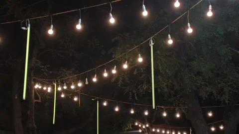 Outdoor Hanging Bulb Lights Creating Warm Night Ambience Stock Footage 321423064