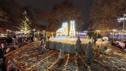 Outdoor ice skating path at a Christmas market in Vienna. skaters gliding along Stock Footage 323505504