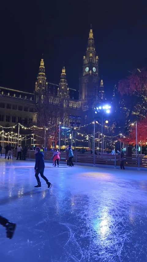 Outdoor ice skating path at a Christmas market in Vienna. skaters gliding along Stock Footage 323505713