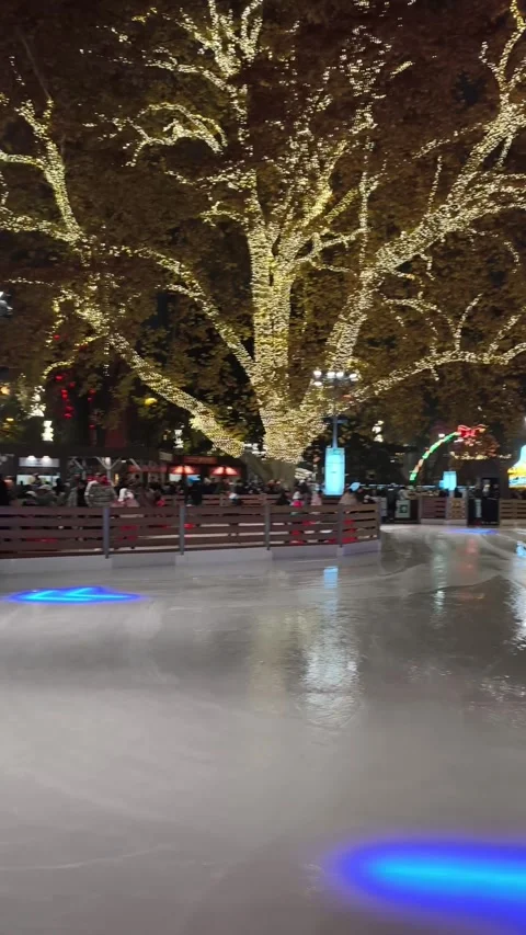 Outdoor ice skating path at a Christmas market in Vienna. skaters gliding along Stock Footage 323508591