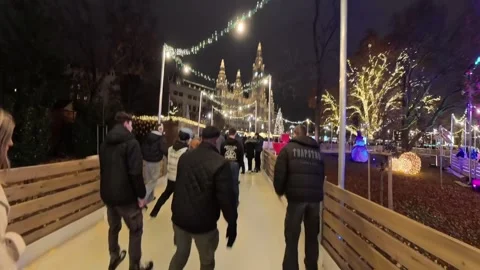 Outdoor ice skating path at a Christmas market in Vienna. skaters gliding along Stock Footage 323510257