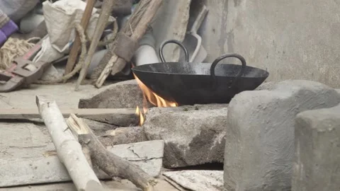Outdoor Indian kitchen cooking flatbread over wood burning fire. Chapati Naan Video stock 131339148
