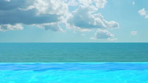 Outdoor Infinity Swimming Pool with Ocean View and Beautiful Sunny Light Blue Sk Video stock 219958725