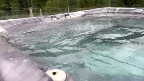 Outdoor jacuzzi hydromassage jets bubbling water Stock Footage 318378431