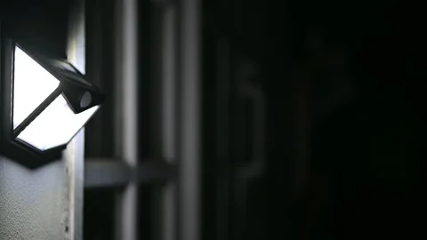 Outdoor LED lamp with motion sensor working above the door that detects movem Stock Footage 150641163