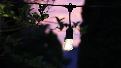 An outdoor light hanging at dusk Stock Footage 245048902