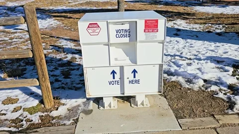 Outdoor mail-in ballot drop box marked Vote Here and Voting Closed, with secure Stock Footage 340264510
