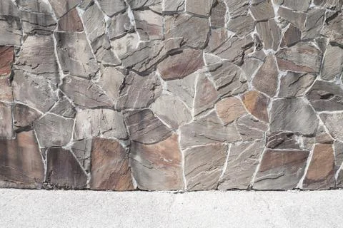 Outdoor mosaic stone wall pattern Stock Photos
