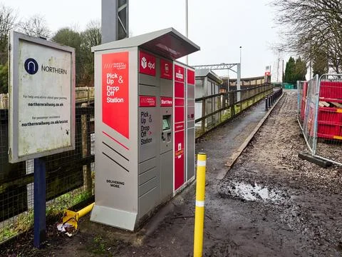 Outdoor parcel locker system at a train station on a cloudy day. Stock Photos