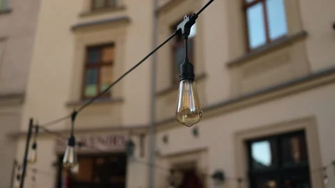 Outdoor party string lights hanging in backyard on bokeh background, summer time Stock Footage 251148108