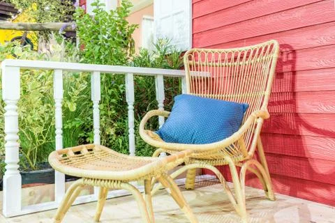 Outdoor patio seating area in house with nice rattan table and chair. Cozy ho Stock Photos