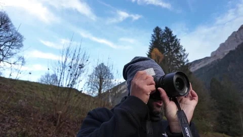 Outdoor photographer mirrorless camera capturing video of Switzerland nature Stock Footage 313275031