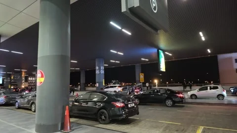 Outdoor pick-up and drop-off zone at KLIA Terminal 2 at night Stock Footage 340939496