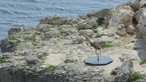 Outdoor pole dance fitness exercise above the sea. Stock Footage
