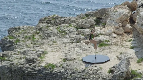 Outdoor pole dance fitness exercise above the sea. Stock Footage