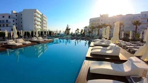Outdoor pool and sun loungers in luxury hotels and resorts. Steadicam shot Stock Footage