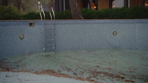 Outdoor pool in a country house without water with garbage at the bottom Stock Footage 276111953