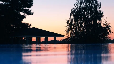 Outdoor pool. Sunset. Orange sky Stock Footage 115495601