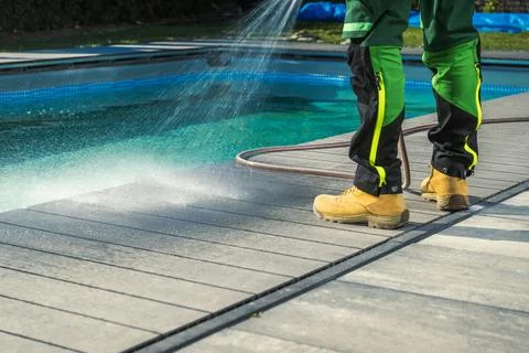 Outdoor Poolside Cleaning Using Garden Hose Stock Photos