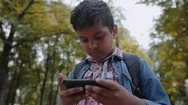 Outdoor Portrait Afro American Happy School Boy With Smartphone. Young Student Stock Footage