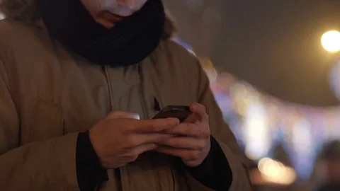 Outdoor portrait of young man using his mobile phone at night. Stock Footage 70880305