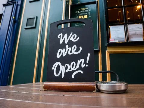 Outdoor pub table table sign "We are Open". Stock Photos