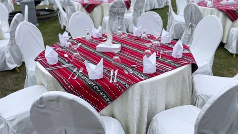 Outdoor Ramadan banquet table setup with red patterned cloth and crescent Stock Footage 329510005