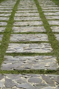 Outdoor rectangular stone tiles pavement path arrange symmetrically Stock Photos