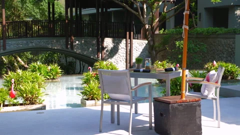 Outdoor relaxation area with comfortable seating by tranquil pond with Video stock 278153702