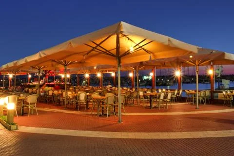 Outdoor restaurant at sunset. Stock Photos