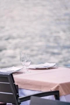 Outdoor restaurant table by the sea Stock Photos