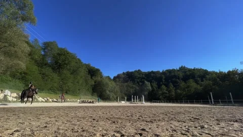 Outdoor school for equestrian training with young kids, low angle Видео 280730156