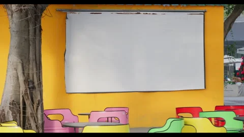 Outdoor Screening Area with Blank Projector Screen and Colorful Chairs Stock Footage 328525589