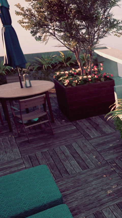 Outdoor seating area with table and plants in a garden setting Stock Footage 340632148