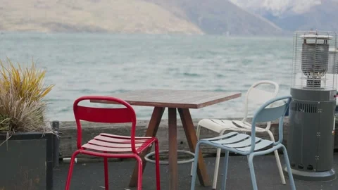 Outdoor seating by the lake in winter empty table and chairs in restaurant Stock Footage 289416404