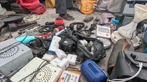 Outdoor secondhand market display featuring discarded electronic devices Stock Footage 346656175