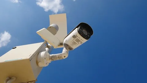 Outdoor security camera on blue sky background Video stock 98856285