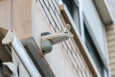 Outdoor security camera mounted on residential building wall Stock Photos