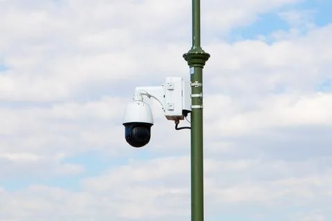 Outdoor security dome video camera, street video camera on lamppost on sky Stock Photos