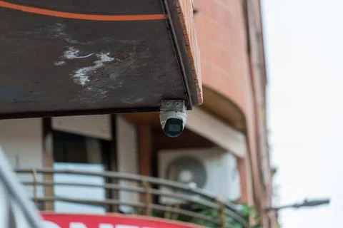Outdoor security surveillance camera mounted on building facade Stock Photos