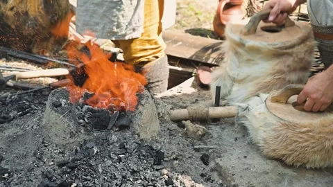 In an outdoor setting, a person is using a prepared bundle to create fire from Stock Footage 345036782