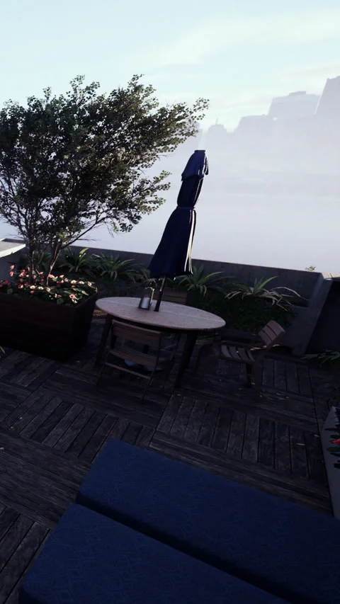 Outdoor setting with table and umbrella in early morning light Stock Footage 339104865