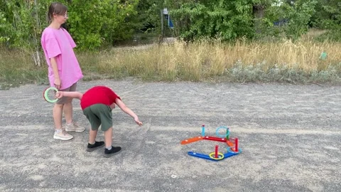 In an outdoor setting, a young boy and his mother share a moment of quality time Stock Footage 316589499